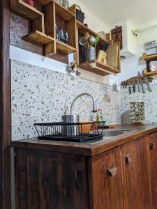 a kitchen with a sink and a counter top at Thee&Thou Cottage in Breaza