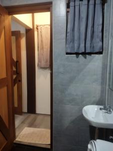a bathroom with a sink and a toilet and a mirror at Asoka Homestay in Senggigi