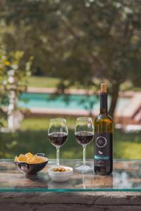 Una botella de vino y dos copas en una mesa. en Paratgea en Llinars del Vallès