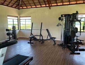 a gym with several treadmills and exercise bikes at Paraíso na terra - Carneiros Beach Resort in Tamandaré