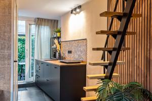 a kitchen with a wooden spiral staircase in the wall at Loft 29 in Zandvoort