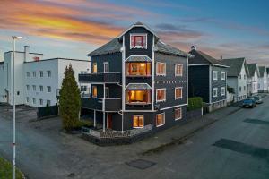 a large black house sitting on the side of a street at Krüger's Crib By Staysville in Stavanger