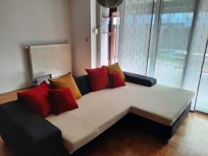 a couch with colorful pillows on it in a room at Apartma Mali grad in Kamnik