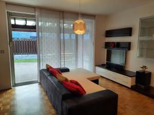 a living room with a couch and a table at Apartma Mali grad in Kamnik