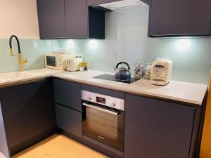 a kitchen with a sink and a stove top oven at Henley Bolt Hole in Henley on Thames