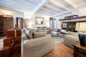 a living room with white furniture and a fireplace at Casa de la Luna in Tías