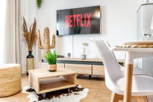 a living room with a table and a desk at Sophie Dream Apartment, City Center , Beachfront in Durrës