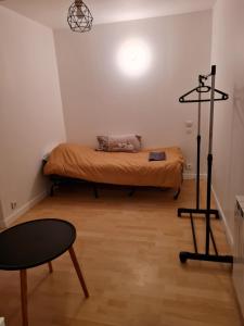a room with a bed and a table in it at maison de ville in Redon +4 photos