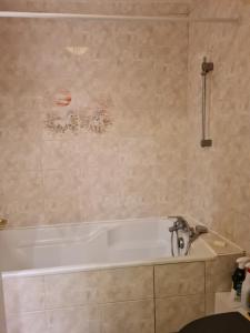 a bathroom with a bath tub and a sink at maison de ville in Redon