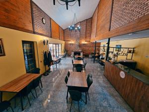 a restaurant with tables and chairs in a room at Tourist Complex Khomi in Ch'argali