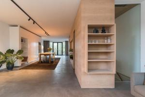a living room with a wall with shelves at City centre Loft on the historic Canal in Utrecht
