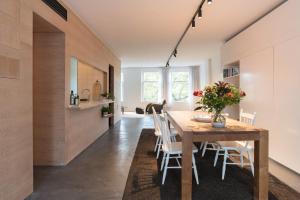 a kitchen and dining room with a table and chairs at City centre Loft on the historic Canal in Utrecht