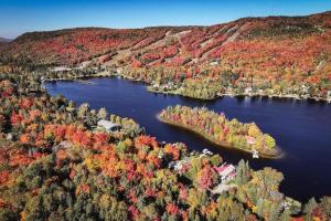 an aerial view of a lake with fall foliage at ST-DO du LAC in Saint-Donat-de-Montcalm