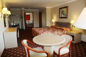 a hotel room with a bed and a table and chairs at Metro Plaza Hotel in Los Angeles