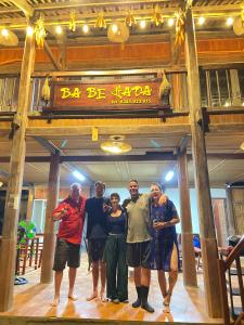 eine Gruppe von Personen, die in einem Restaurant unter einem Schild stehen in der Unterkunft Ba Bể Hada Homestay in Ba Be18