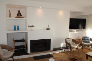 a living room with a fireplace and a tv at El Remanso - Suite 104 in Punta del Este