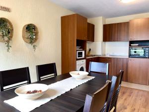 a kitchen with a table with two bowls on it at Private Suite at Comfort Bansko in Bansko