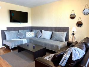 a living room with a couch and a table at Private Suite at Comfort Bansko in Bansko