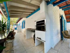 a kitchen with a counter and a table and chairs at Casa Azul in São Sebastião