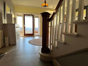 a hallway with a staircase and a door with a view at The Vurpillat in Hermosa Beach