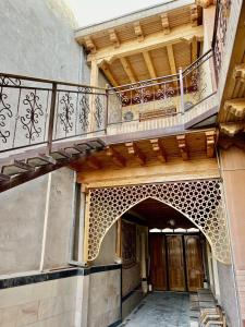 an entrance to a building with a balcony at Arabon Hotel in Bukhara