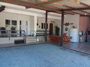 a kitchen and a living room with a patio at Pousada Max Boesing in São Francisco do Sul