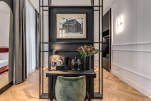 a room with a table with a vase of flowers at Residenza Piranesi Boutique Hotel in Rome