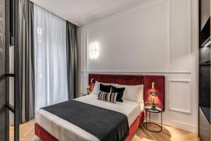 מיטה או מיטות בחדר ב-Residenza Piranesi Boutique Hotel