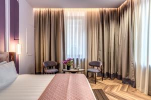 Ένα ή περισσότερα κρεβάτια σε δωμάτιο στο THE STEPS Hotel - by Eitch Collection