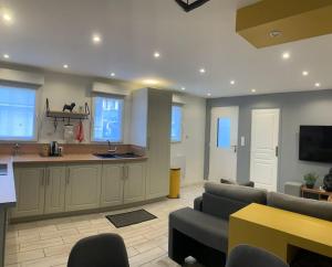 a living room with a couch and a kitchen at Charmante petite maison de ville in Calais +7 photos