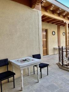 a white table and chairs on a patio at Arabon Hotel in Bukhara