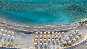 una vista aerea su una piscina d'acqua con ombrelloni di Ariadne Beach - Adults Only ad Ágios Nikólaos