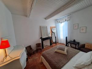 a bedroom with a bed and a lamp and a couch at La maison SPA, PISCINE et CLIMATISATION in Sainte-Vallière +75 photos