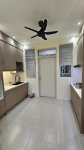 a large kitchen with a ceiling fan in a at SYG12 Homestay Dalur Presint 18 in Putrajaya