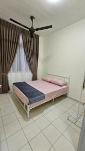a bedroom with a bed and a ceiling fan at SYG12 Homestay Dalur Presint 18 in Putrajaya