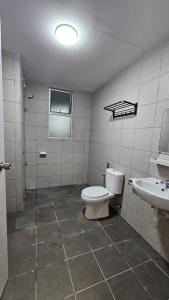 a bathroom with a toilet and a sink at SYG12 Homestay Dalur Presint 18 in Putrajaya