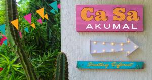 a sign that reads ca sa ayun on a wall at CaSa AKUMAL in Akumal