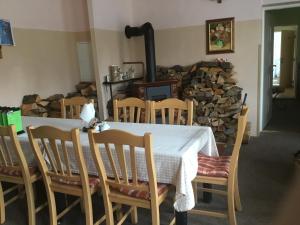 a dining room with a table and chairs and a fireplace at Penzion Real in Bedřichov