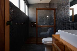 a bathroom with a shower and a toilet and a sink at Las Privadas / Casa X By Nardazul in Oaxaca City +4 photos