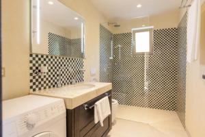 a bathroom with a sink and a washing machine at Villa Tilia in Kras +25 photos