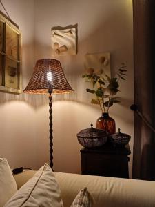 a bedroom with a lamp and a vase of flowers at Calma in Perdika