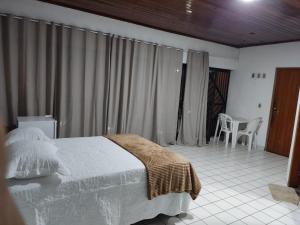 a bedroom with a bed and a room with a table at AL EVENTOS in Teresina