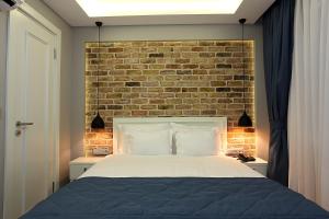 a bedroom with a brick wall and a bed at Taksim Santa Lucia Hotel in Istanbul