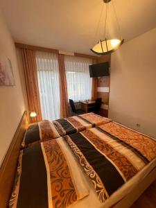 a bedroom with a large bed in a room at Pension Strasser in Bad Schallerbach