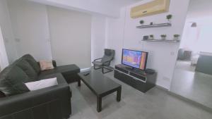 a living room with a couch and a tv at STAY Universal Studio in Engomi