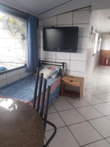 A television and/or entertainment centre at Hostel Ancorados Drumond