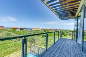 a balcony with a view of the ocean at Oceans Edge 3, Zimbali Estate in Ballito