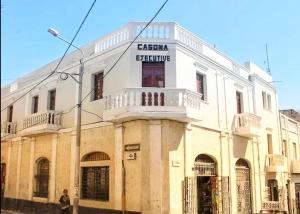 a white building with a sign on it at HOSTAL espinoza in Arequipa