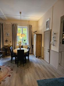 a dining room with a table and chairs and a window at Gîte l'école est finie 6 personnes 4pièces in Lusse