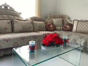 a living room with a couch and a glass table at White Rooms by Sineth in Ratmalana